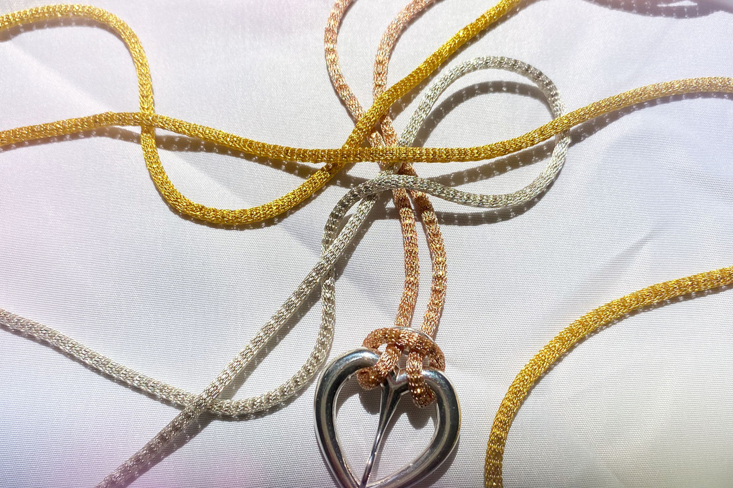 Love buckle pendant with mesh coated chain