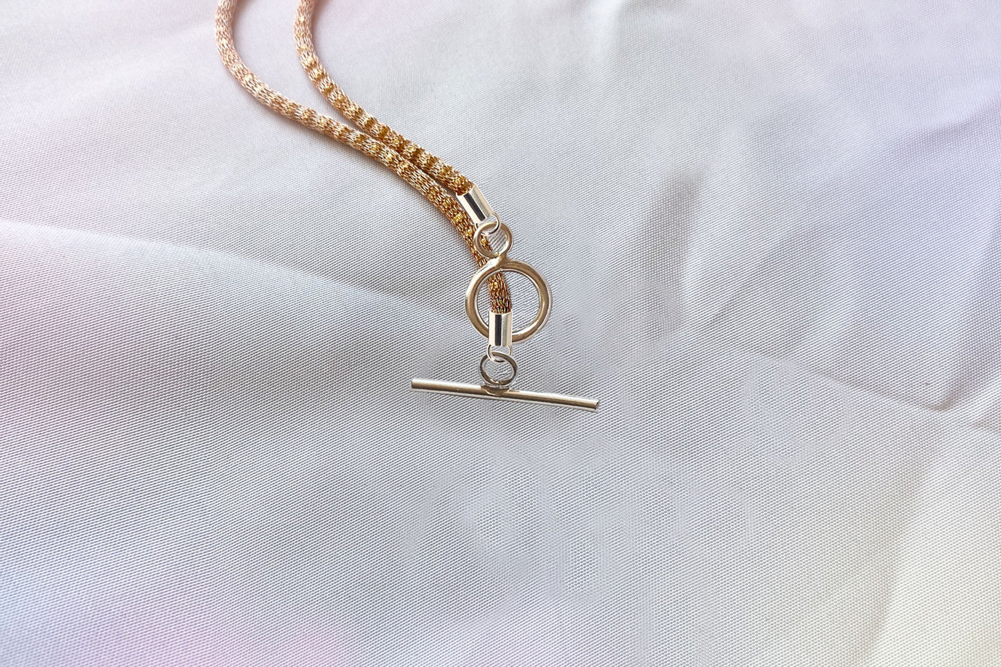 Love buckle pendant with mesh coated chain